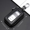 Black retro PU leather car key case with a clear window and metal hook resting on a dark surface.