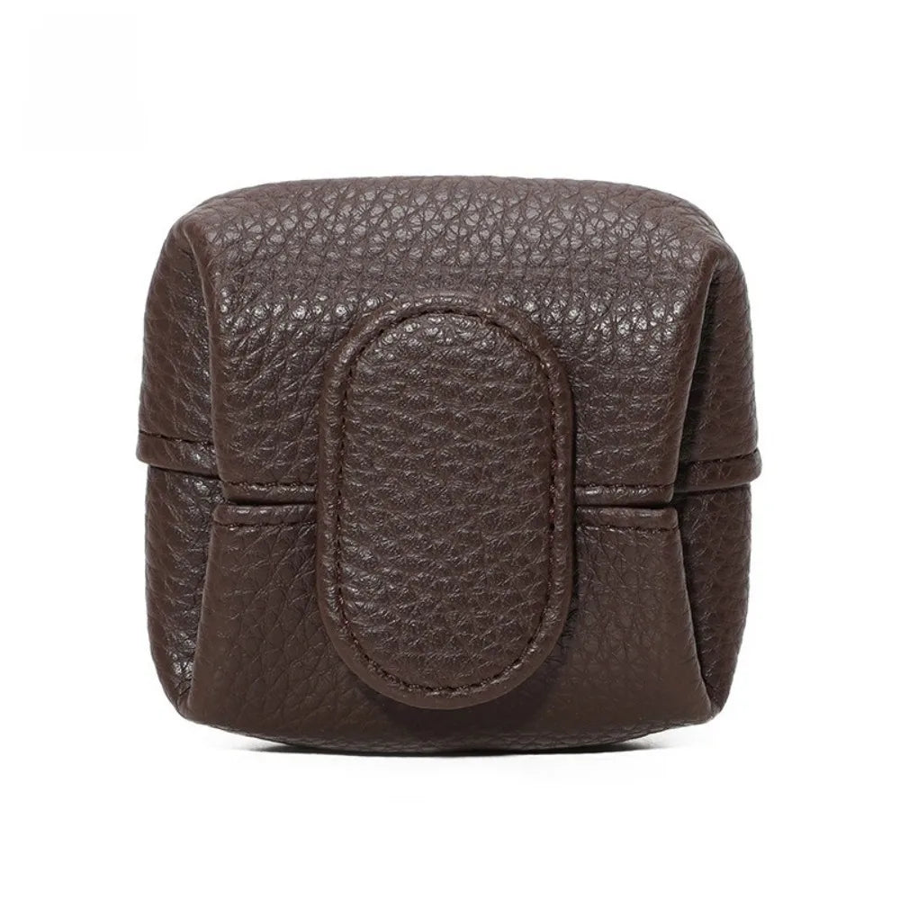 A dark brown, textured leather coin purse with a snap closure.
