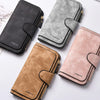 Three leather zippered coin purses in black, gray, and rose gold tones displayed on a white surface.