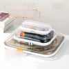 Clear plastic foldable zipper storage pouches for travel and organization displayed on a white surface.