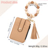 Tan leather card holder with a gold keychain bangle and tassel