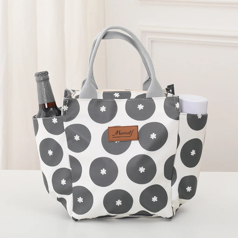 Bolsa térmica de tela gris con patrón a cuadros de círculos grises y blancos.