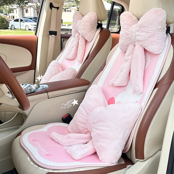 Pink bowknot car headrest pillow with lumbar support in a beige car interior.