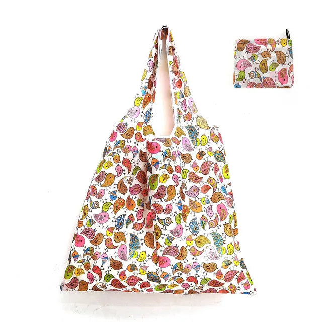 A reusable eco tote shopping bag featuring a colorful pattern of various fruits and vegetables.