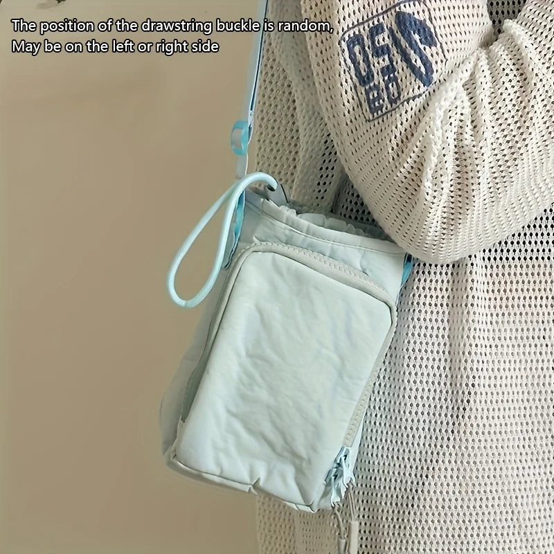 A light blue adjustable water bottle carrier bag with a phone pocket is shown attached to a person's clothing.