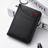 A black ultra-thin PU leather credit card wallet is shown resting on a white surface next to some stacked books.