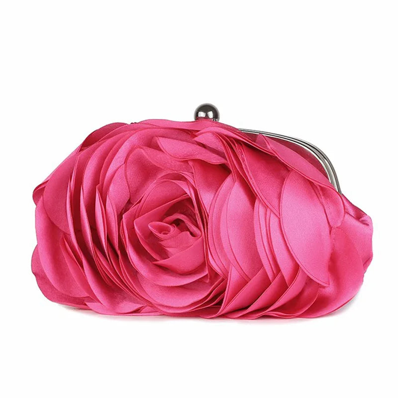 A vibrant pink rose floral evening clutch bag with a silver chain strap.