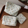 White quilted cosmetic storage pouches with a light blue cat print featuring small yellow cats.