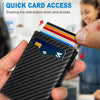 A hand holds a black textured card holder displaying an RFID blocking card with a wireless symbol.