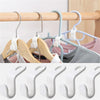 A set of multi-hook wardrobe organizers in light wood and pastel colors hanging on a wooden rod.
