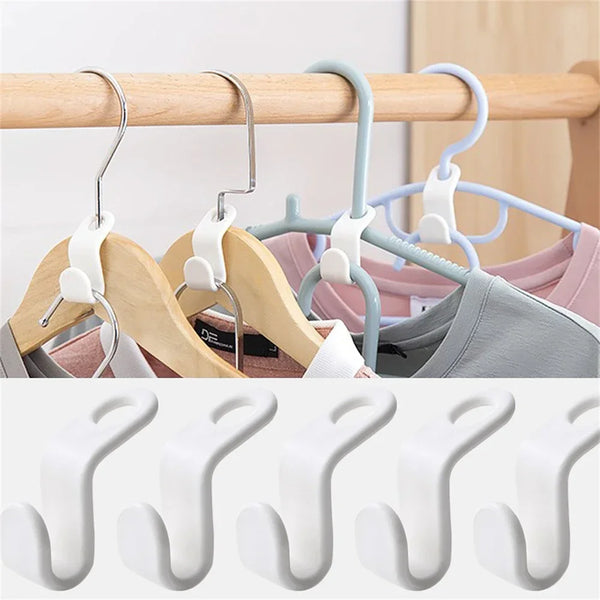 A set of multi-hook wardrobe organizers in light wood and pastel colors hanging on a wooden rod.
