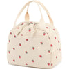 A beige corduroy lunch bag with light pink strawberries scattered across the fabric.