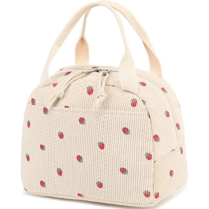 A beige corduroy lunch bag with light pink strawberries scattered across the fabric.