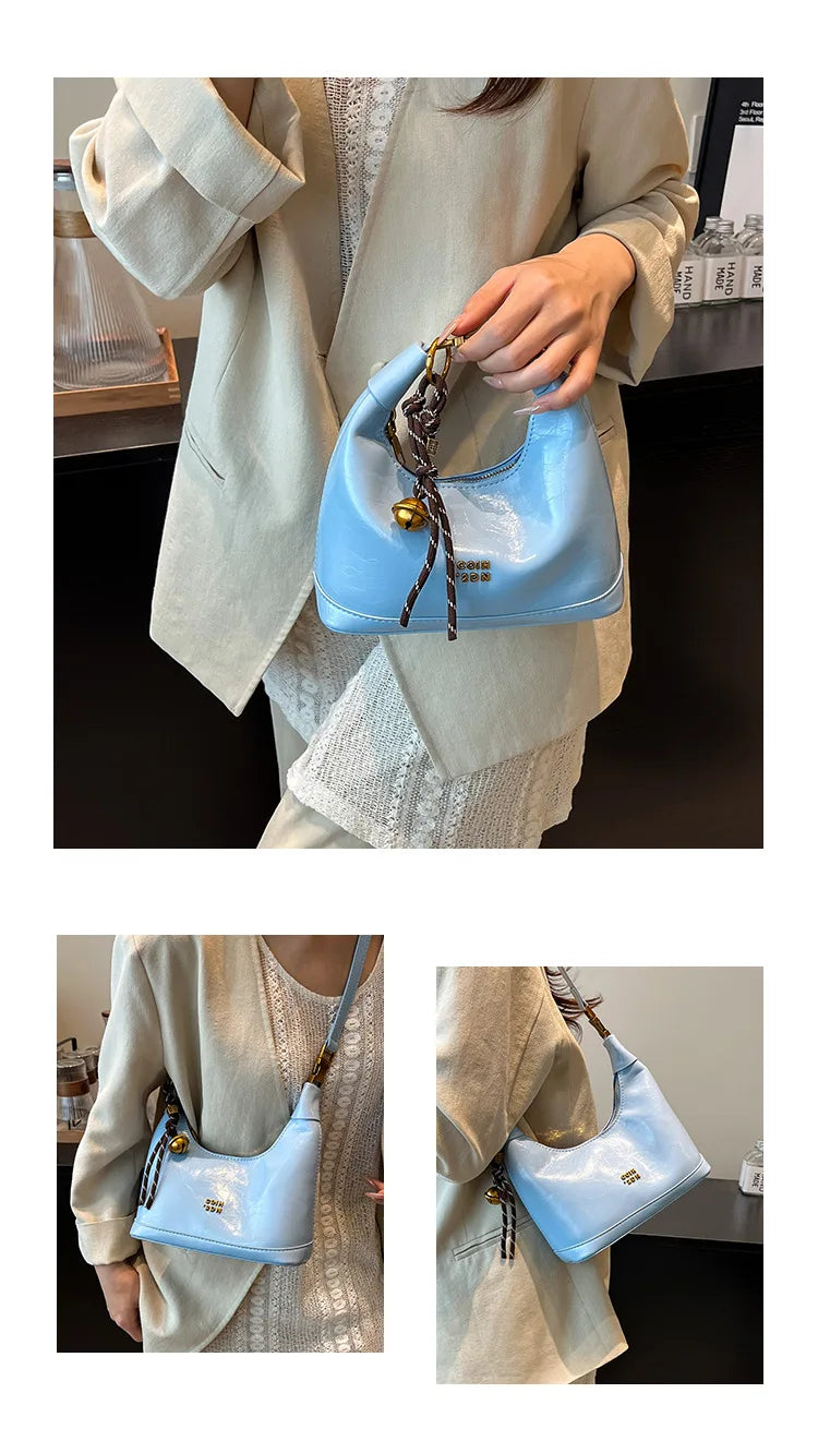 A light blue retro PU leather shoulder bag with a gold chain strap is shown being held by a person.