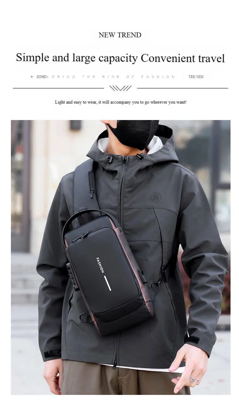 A person wearing a gray hooded jacket is carrying a black anti-theft crossbody chest bag on their chest.