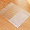 Triple pack of frosted clear card sleeves for ID and credit cards placed on a wooden surface