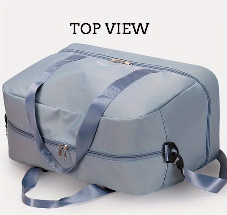 Top view of a light blue expandable nylon travel duffle bag with gray straps.