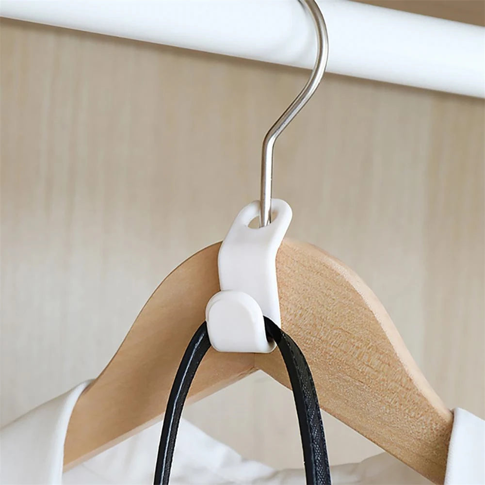 A multi-hook wardrobe organizer is shown hanging on a white rod, featuring a wooden hanger and a white hook.