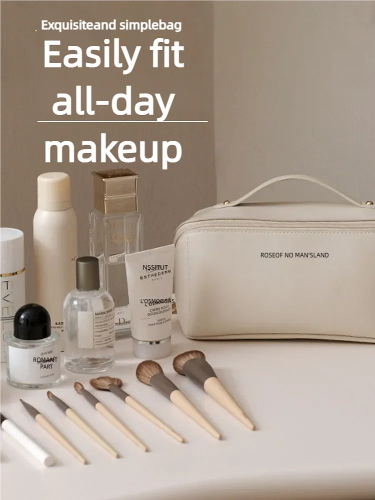 A light beige cosmetic storage bag is shown with various makeup products and brushes on a white surface.