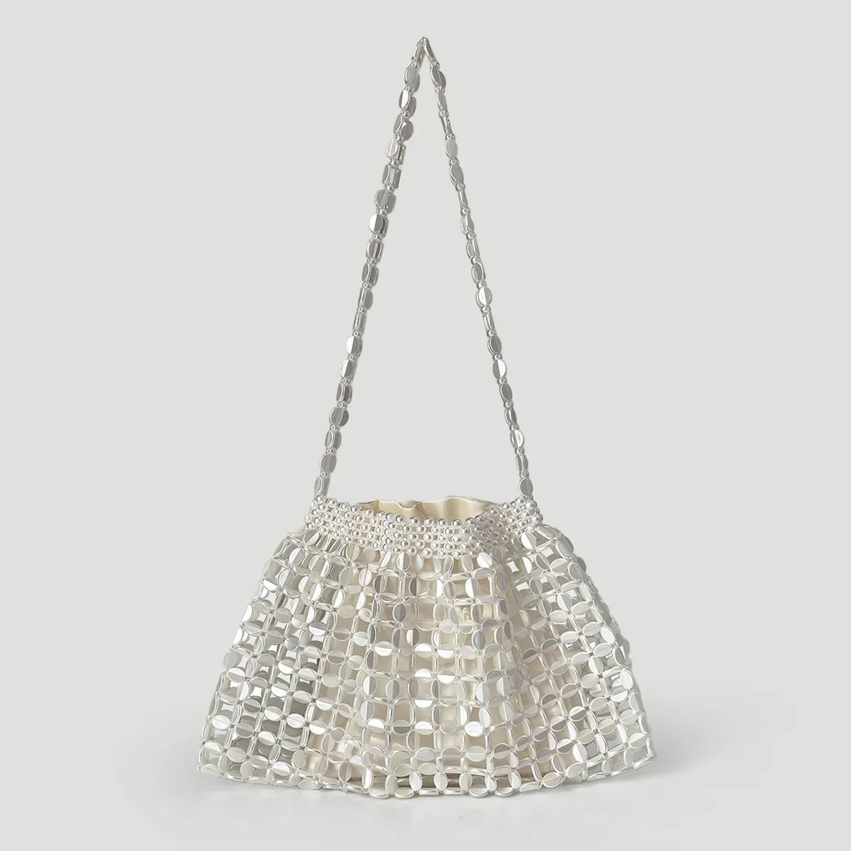 A handmade dumpling bag featuring silver and gold beads, displayed against a light gray background.