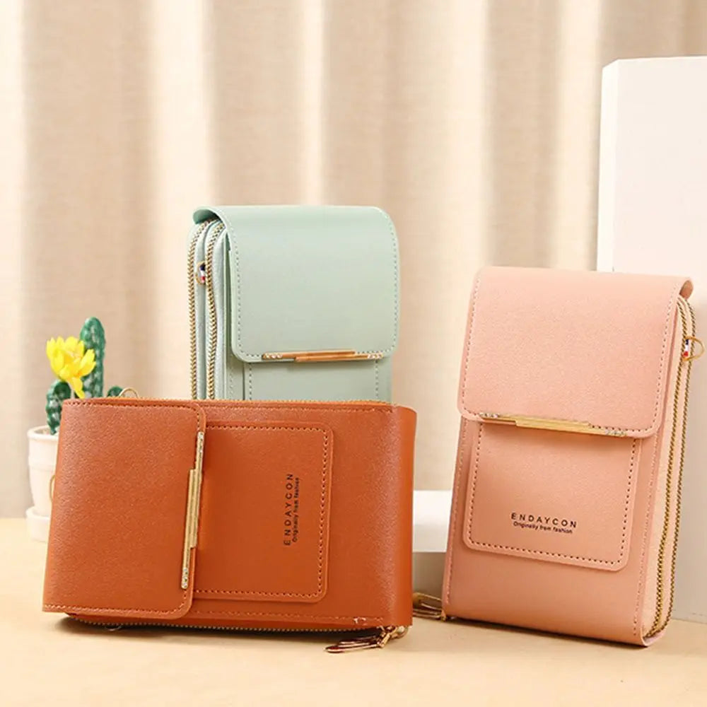 A set of three brown and mint green RFID-protected touch screen crossbody bags displayed on a light surface.