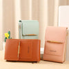 A set of three brown and mint green RFID-protected touch screen crossbody bags displayed on a light surface.