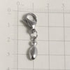 Silver stainless steel alphabet letter charm with a lobster clasp shown against a ruler.