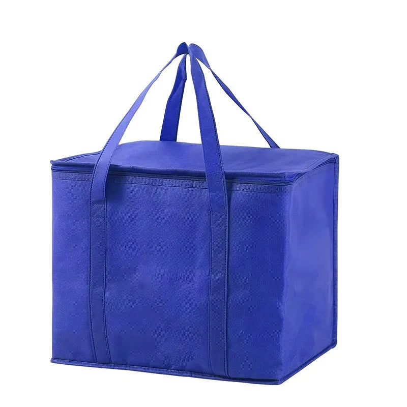 A royal blue foldable insulated grocery and food cooler bag with handles.