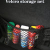 Black velcro storage net bag filled with various colorful items like bottles and containers.