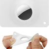 A white MagSafe card wallet with a built-in pocket for an AirTag, shown being held by a hand.