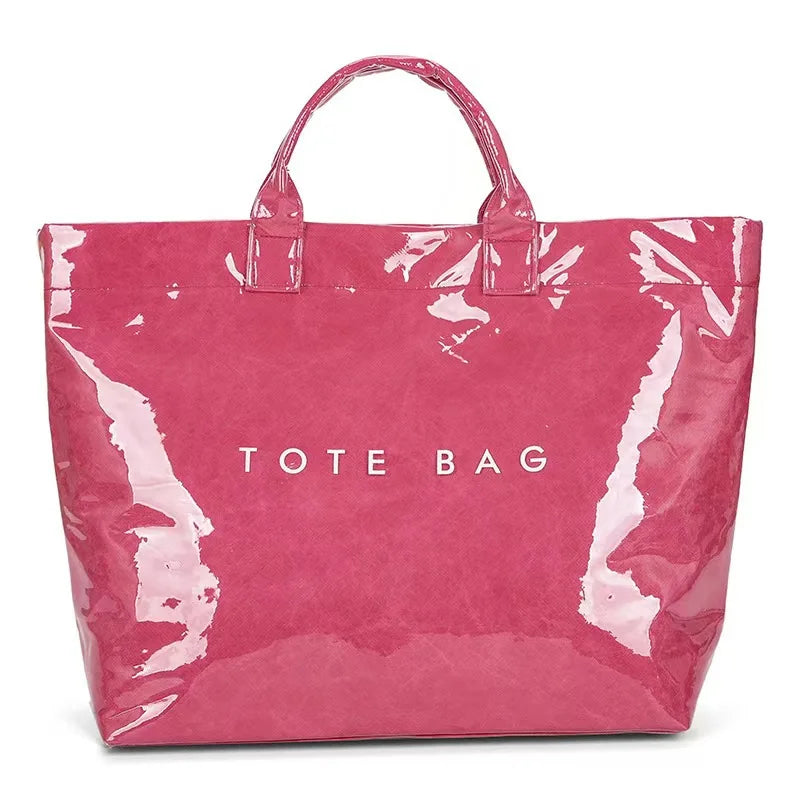A vibrant pink transparent waterproof PVC tote bag with a handle.