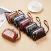 A collection of vintage brown and blue PU leather compact wallets with leather straps arranged on a beige surface.