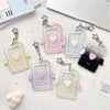 A collection of clear and pastel acrylic photocard holders with heart shapes and angel wings on a white background.