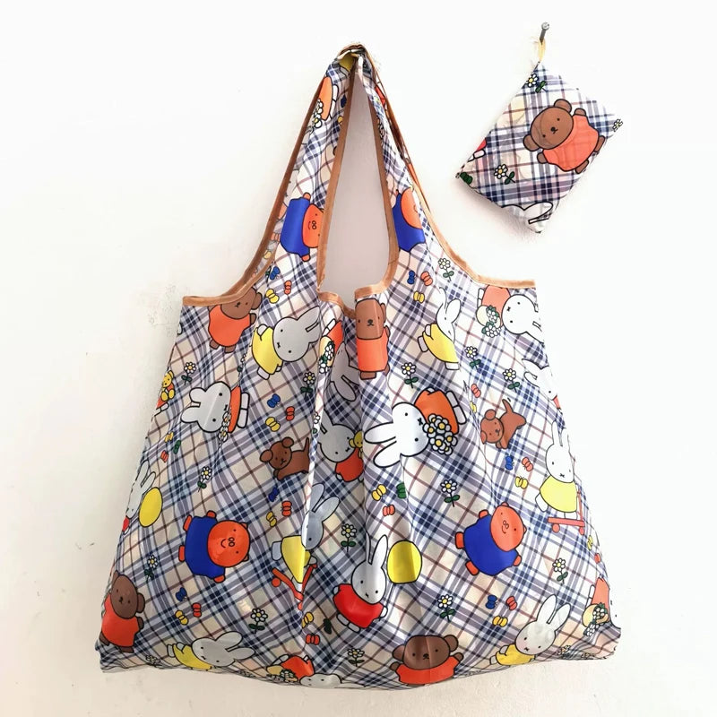 A patterned fabric folding shopping bag featuring cute animal characters like Miffy and others.