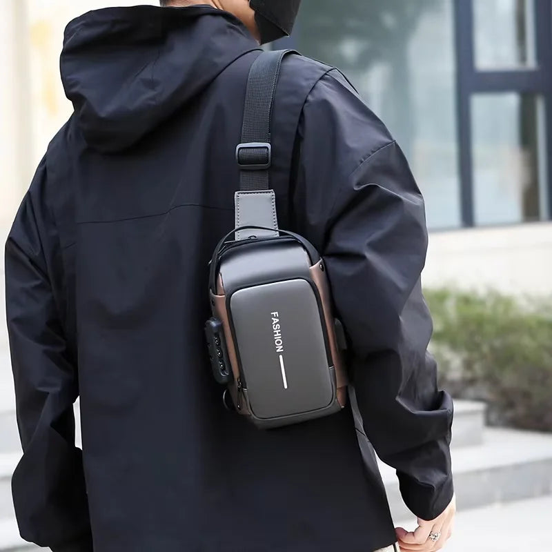 A person wearing a black jacket is carrying a dark gray Oxford sling chest bag with a phone pocket on their shoulder.