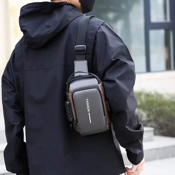 A person wearing a black jacket is carrying a dark gray Oxford sling chest bag with a phone pocket on their shoulder.