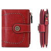 A red leather multi-fold wallet with stitching and a protective RFID shield.