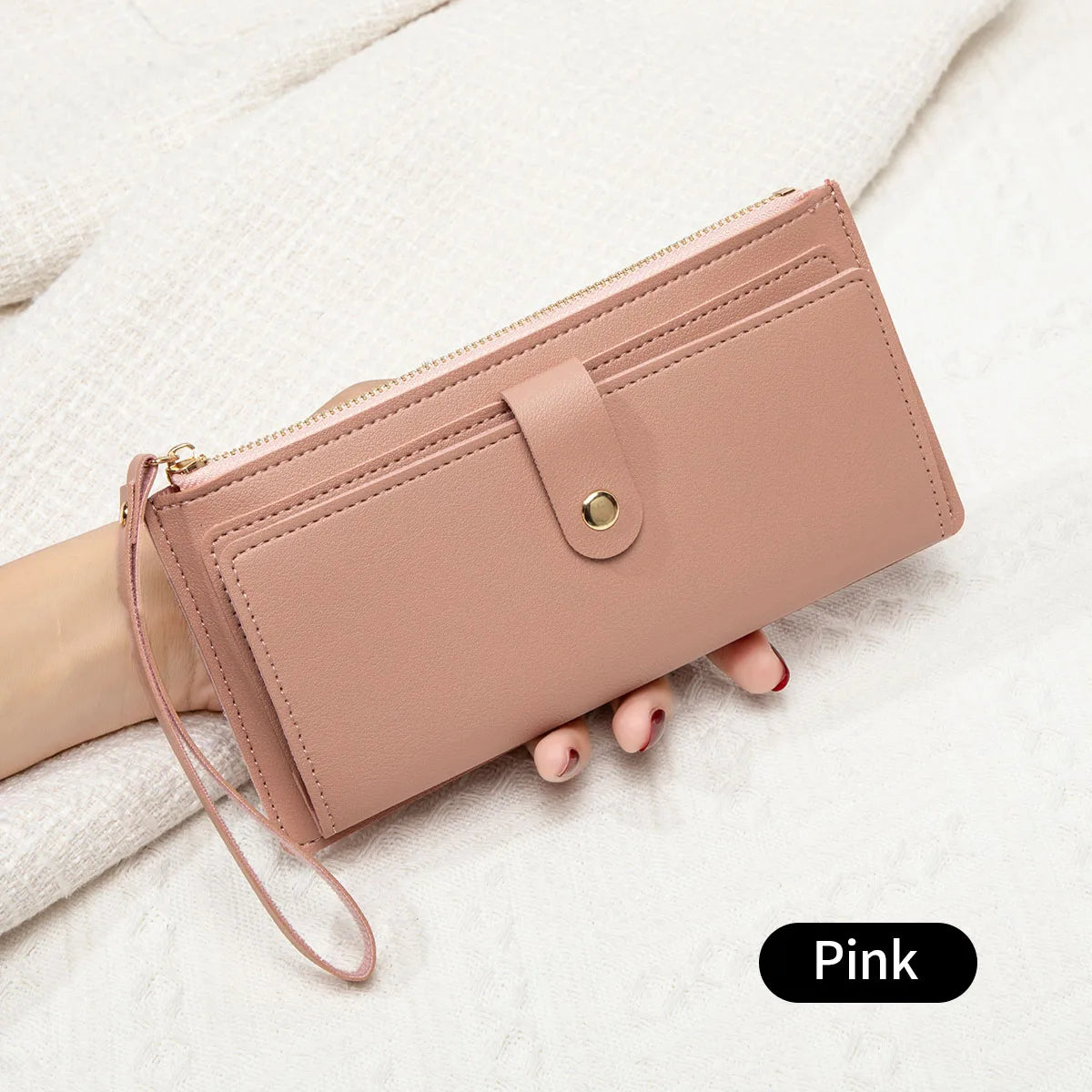 A pink elegant PU leather coin purse and card holder resting on a white textured surface.