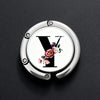 Silver foldable letter hanger hook with a stylized letter Y and floral accents