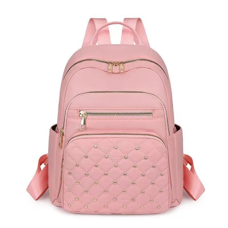 Pinkes gestepptes Kunstleder-Daypack mit verstellbaren Riemen und Reißverschlüssen.