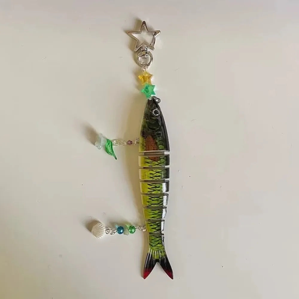 A simulation fish keychain featuring a green body, yellow accents, and a silver star charm.