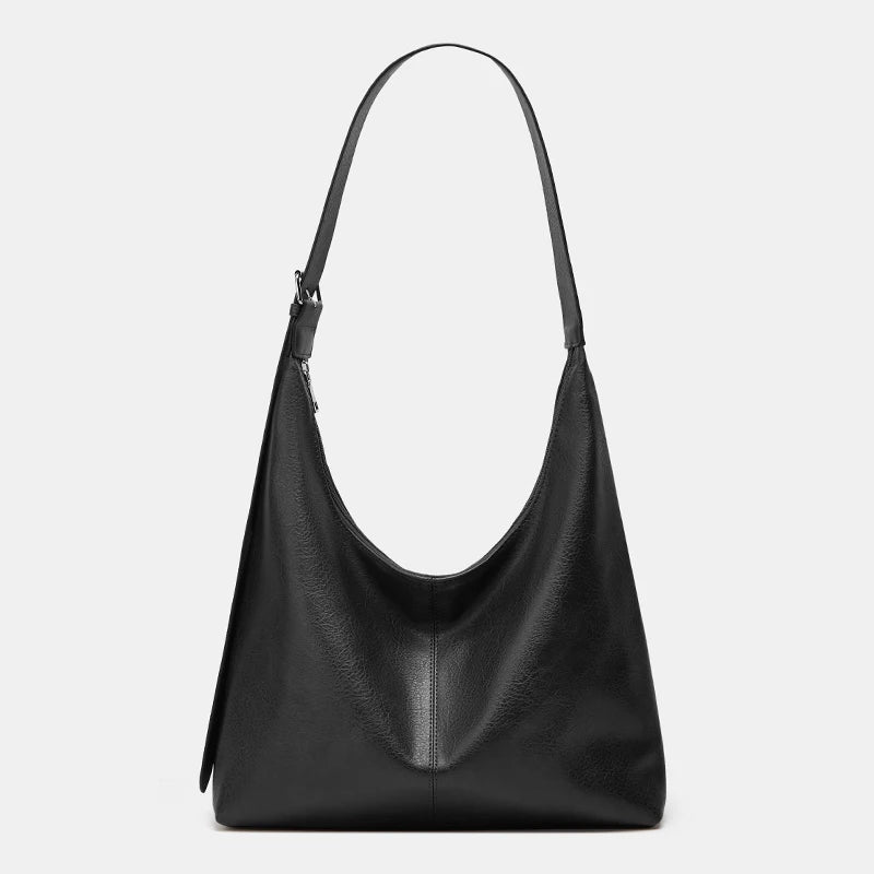 A black women's soft PU leather retro tote bag with a zipper closure.