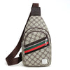 A beige and black patterned printed crossbody sling bag with a brown strap and green, red, and black stripes.