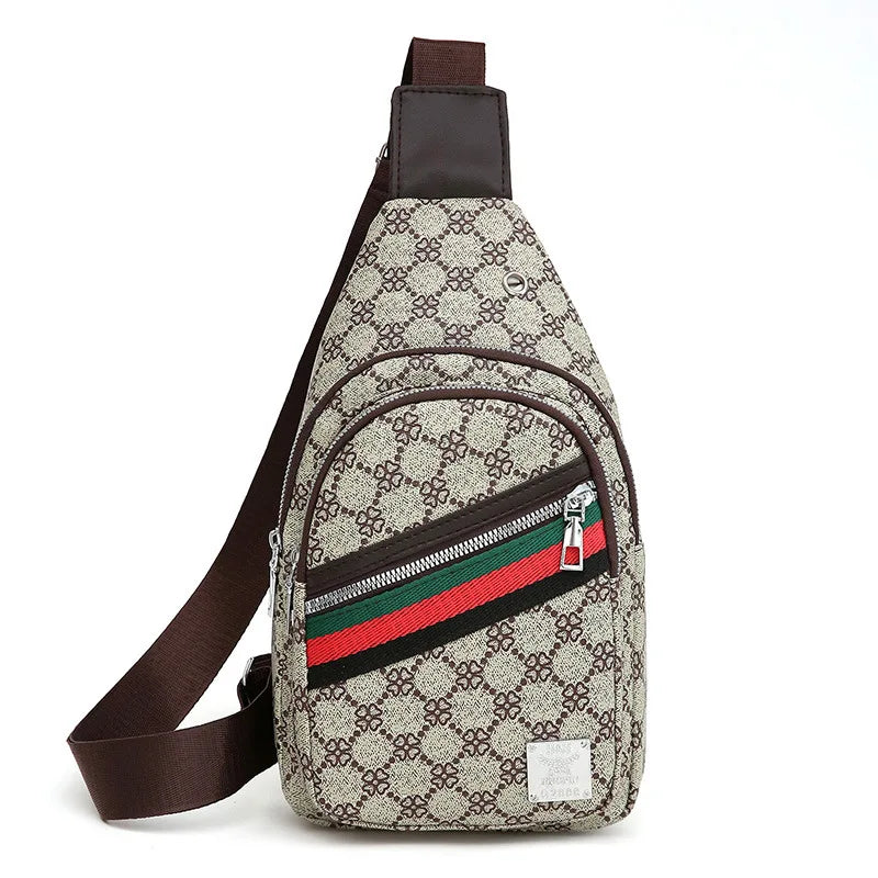 A beige and black patterned printed crossbody sling bag with a brown strap and green, red, and black stripes.