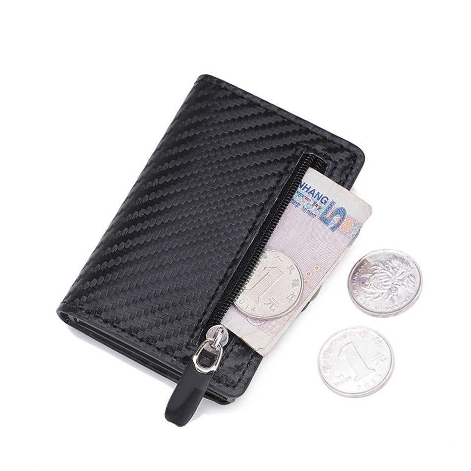 Black carbon fiber wallet with a zipper and several silver coins