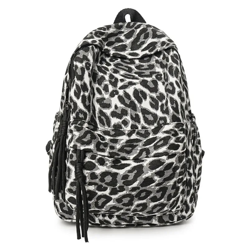 A black and white leopard print canvas backpack.
