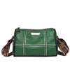 A dark green luxury cowhide shoulder bag with white stitching and brown leather trim.