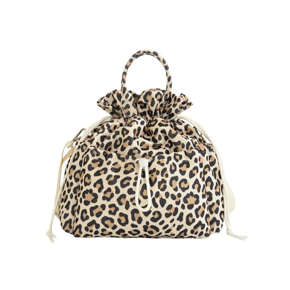 A beige and brown leopard print insulated waterproof lunch bag with a drawstring closure.
