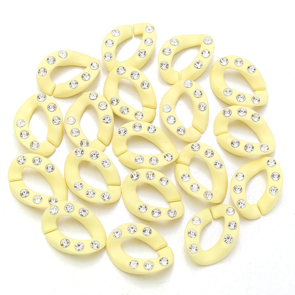 A collection of light yellow acrylic link chain connectors for DIY jewelry and bag making