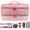 A pink double-layer storage case for a hair dryer and various accessories like a dryer, nozzle, and brush attachments.
